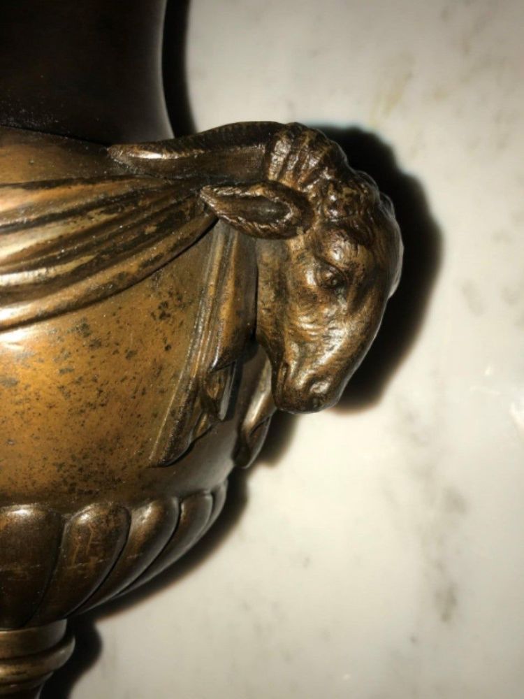 Pair of 19th Century Urns on Marble Stands Bearing Cherubs and Rams Heads