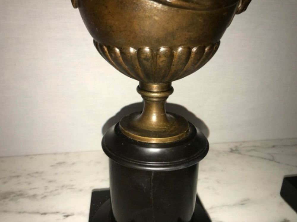 Pair of 19th Century Urns on Marble Stands Bearing Cherubs and Rams Heads